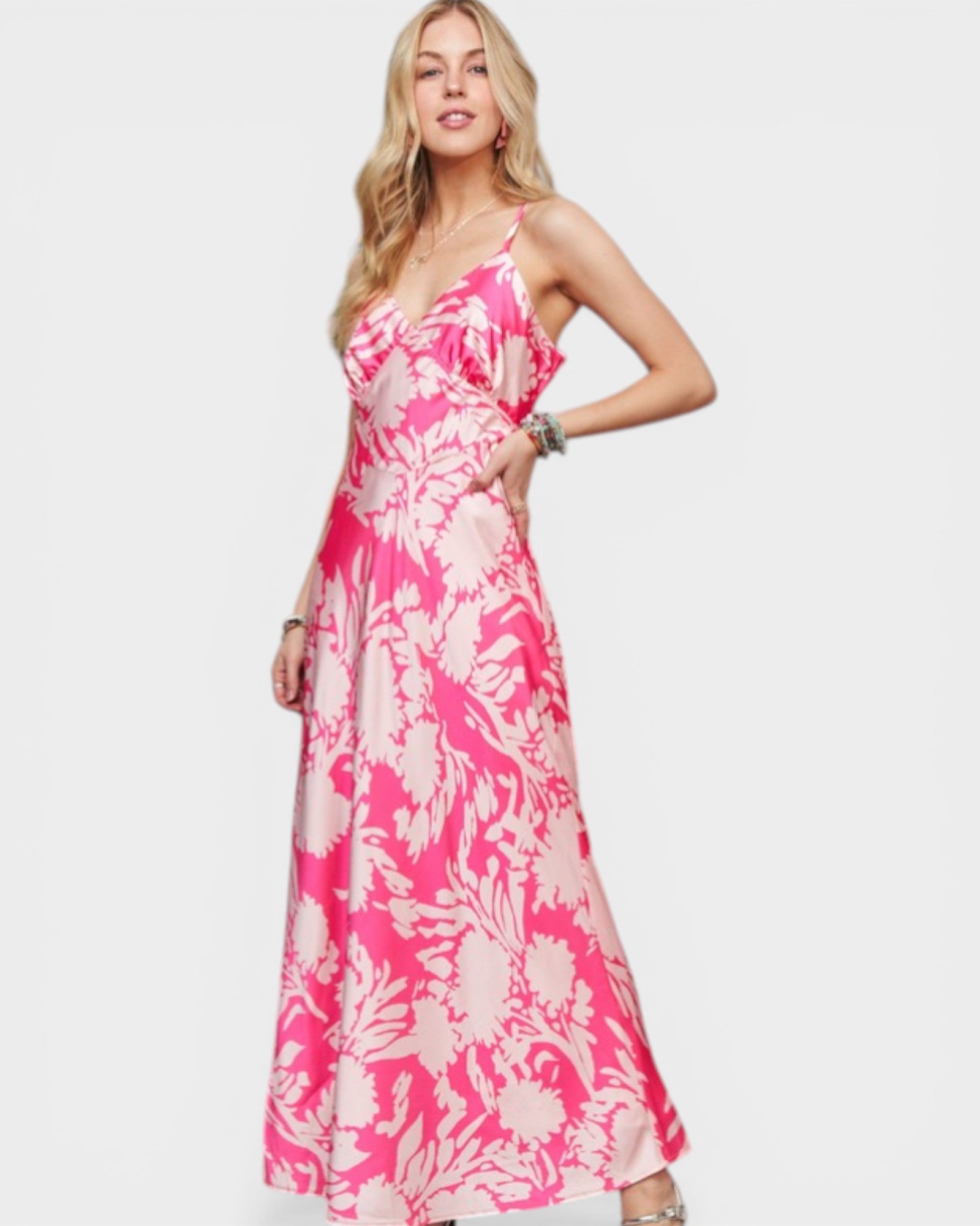 Woman wearing a pink floral dress on a white background