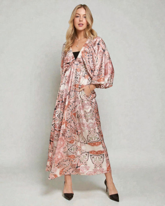 Woman wearing a floral patterned dress on a plain background