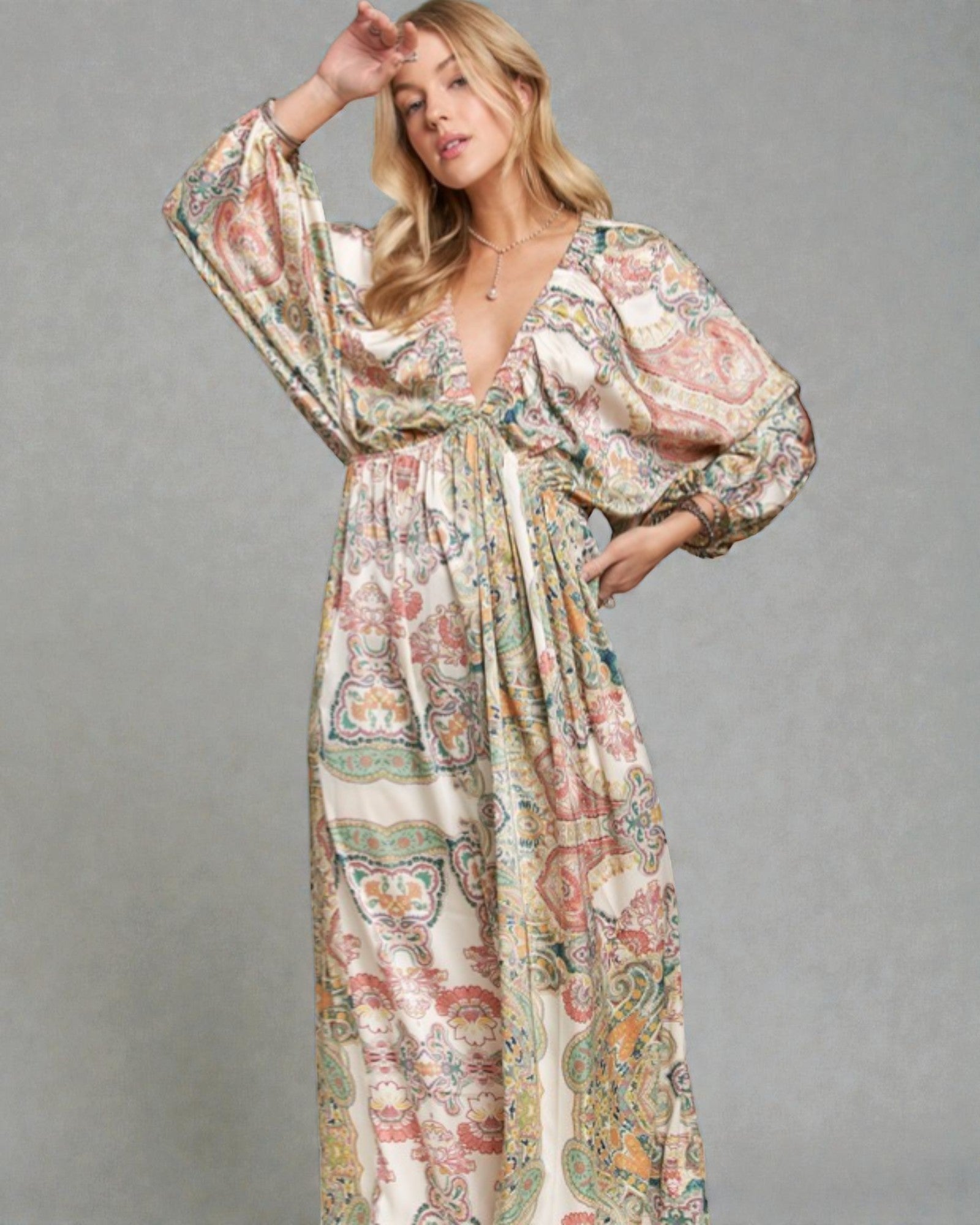 Woman wearing a floral patterned dress against a gray background