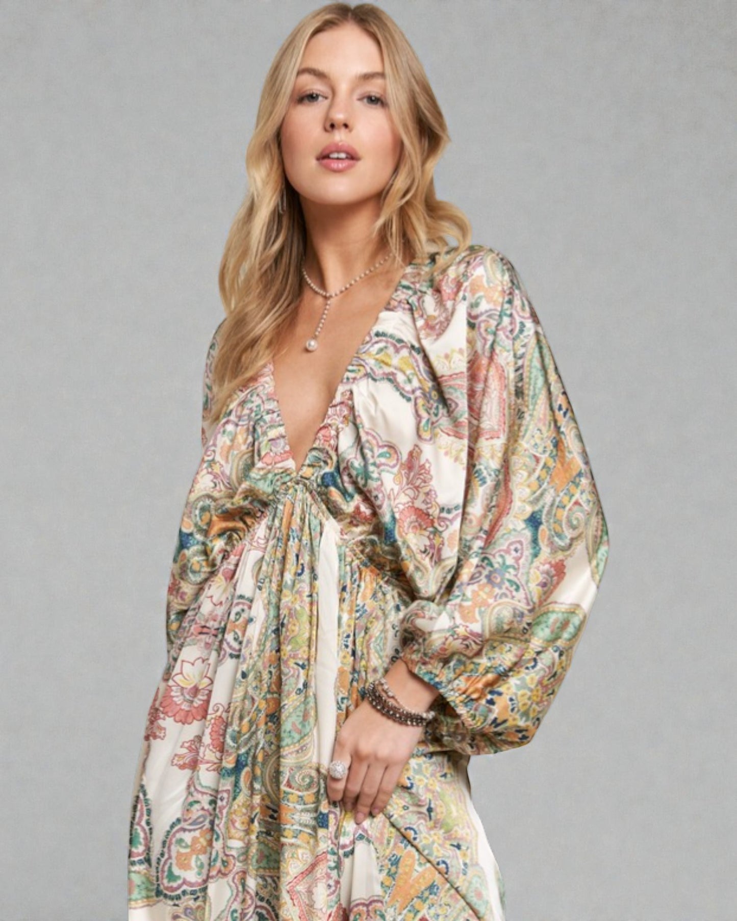 Woman wearing a floral dress against a gray background