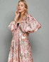 Woman wearing a floral dress against a gray background