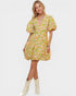 Woman wearing a floral dress with puff sleeves on a white background