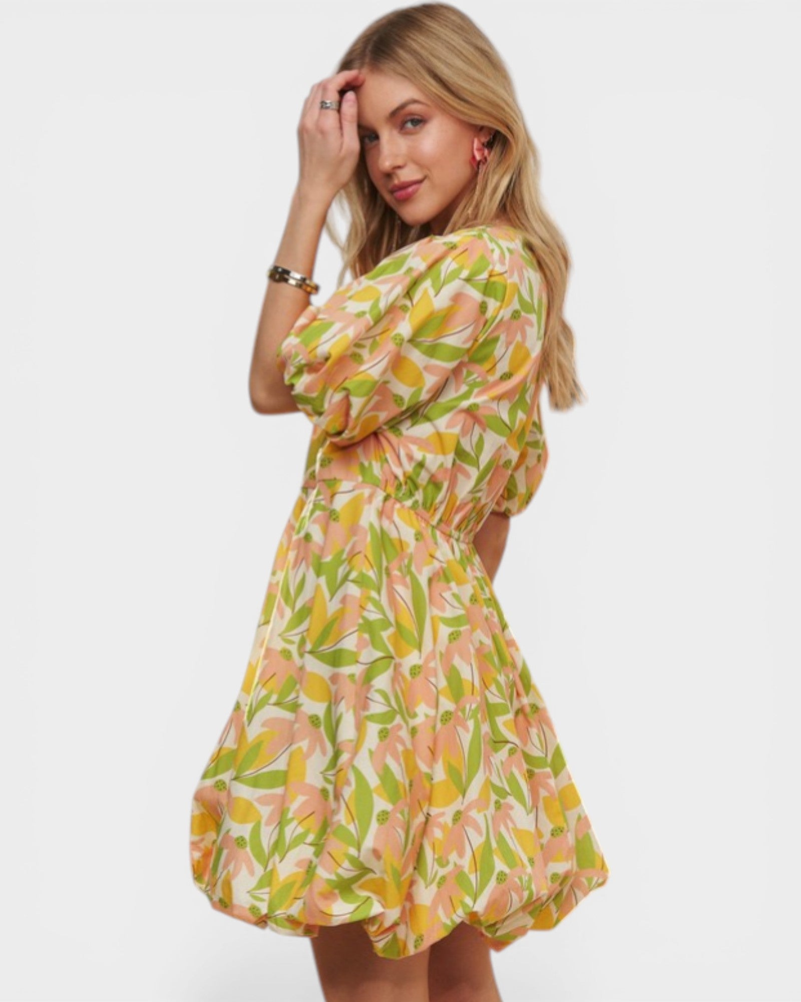 Woman wearing a colorful floral dress on a white background