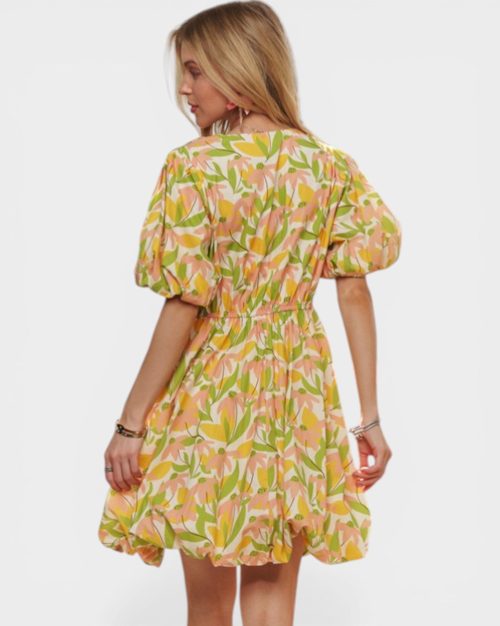 Woman wearing a colorful floral dress on a white background