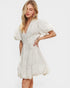 Woman wearing a white dress on a plain background