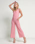 Woman wearing a pink jumpsuit on a white background