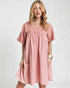 Woman wearing a pink dress on a white background