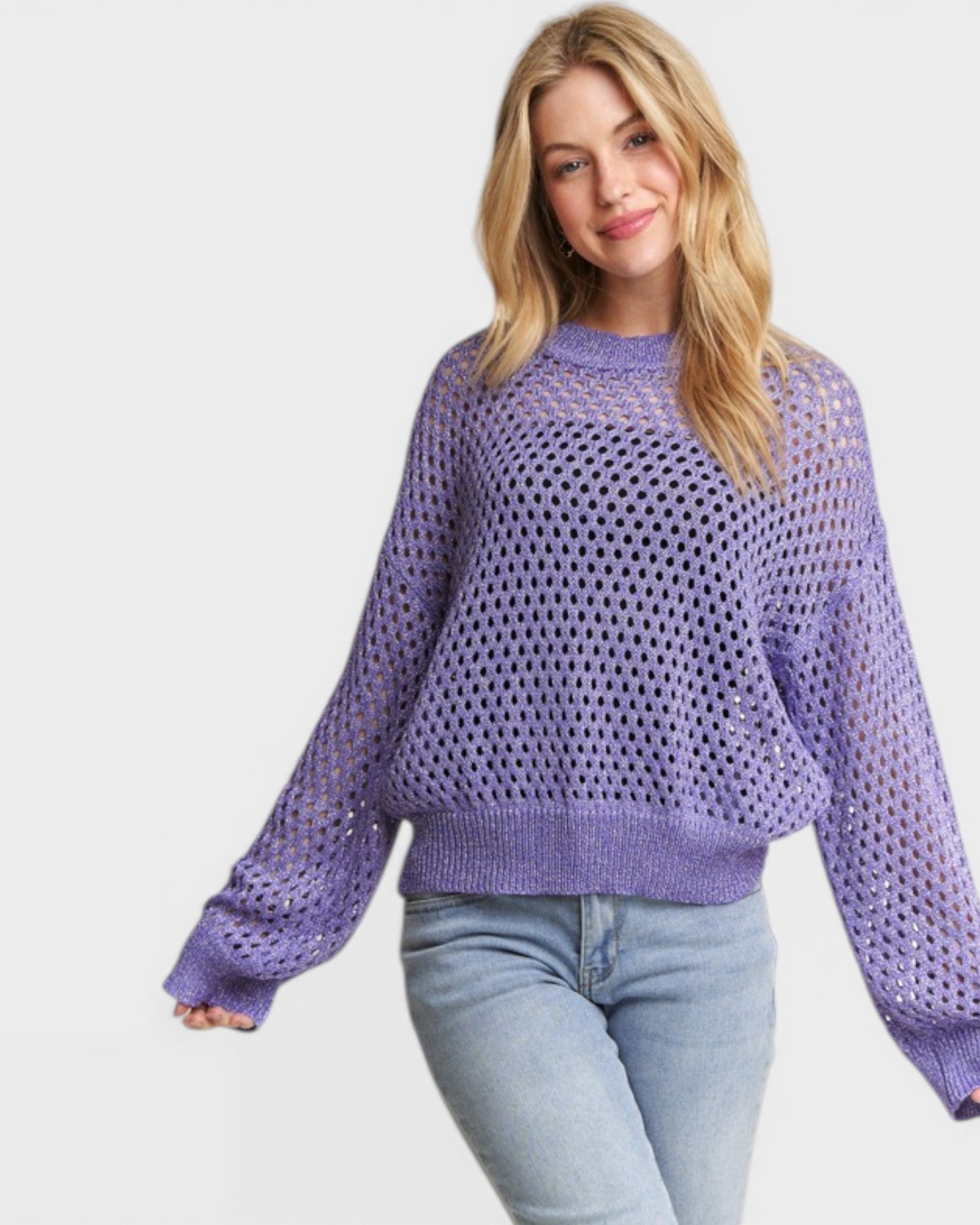 Woman wearing a purple sweater with a white background