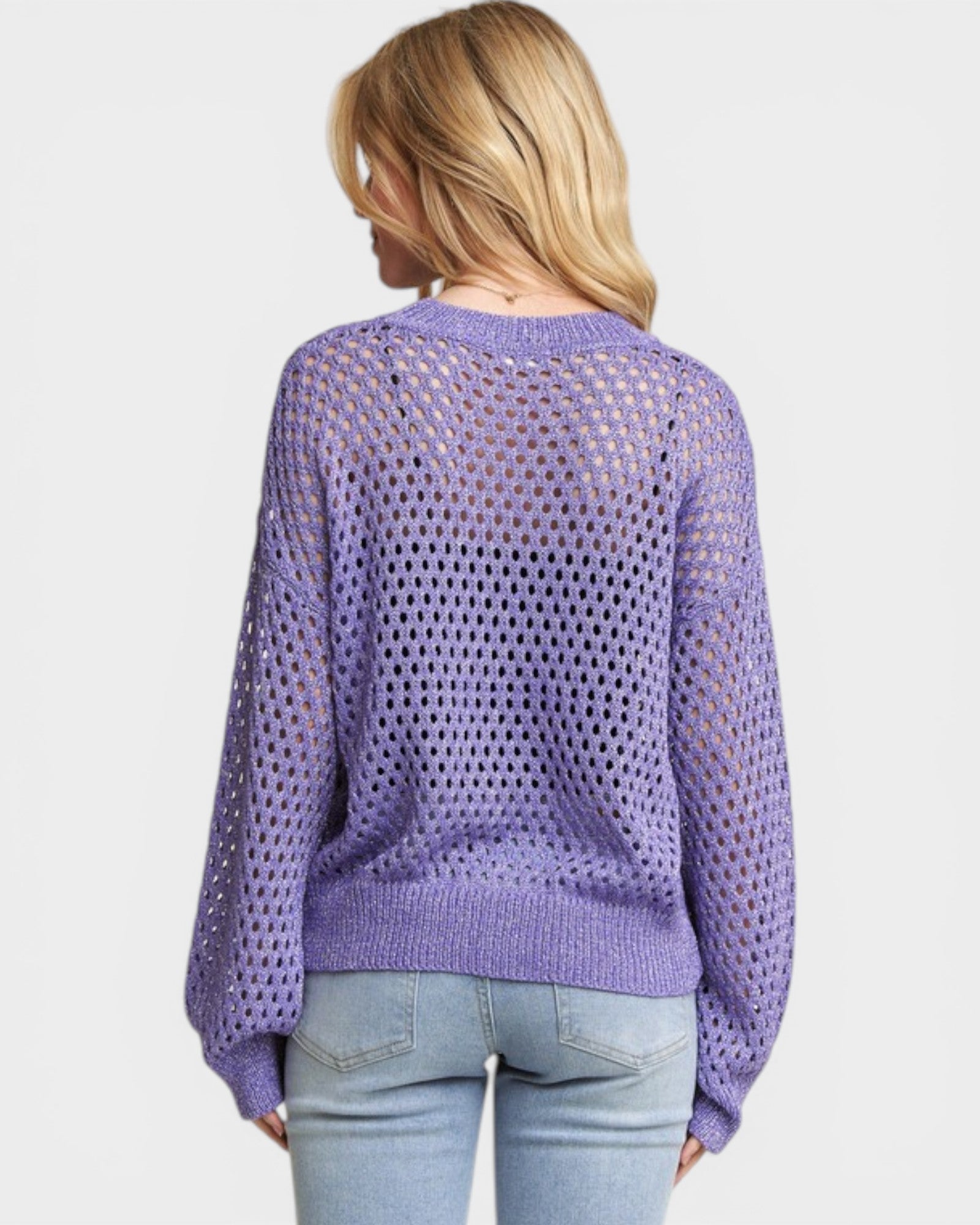 Person wearing a purple mesh sweater on a white background