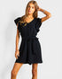 Woman wearing a black romper on a white background