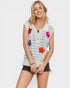Woman wearing a colorful striped vest with floral patterns on a white background
