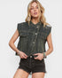 Woman wearing a black denim vest with embellishments on a white background