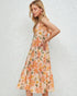 Woman wearing a floral dress against a plain background
