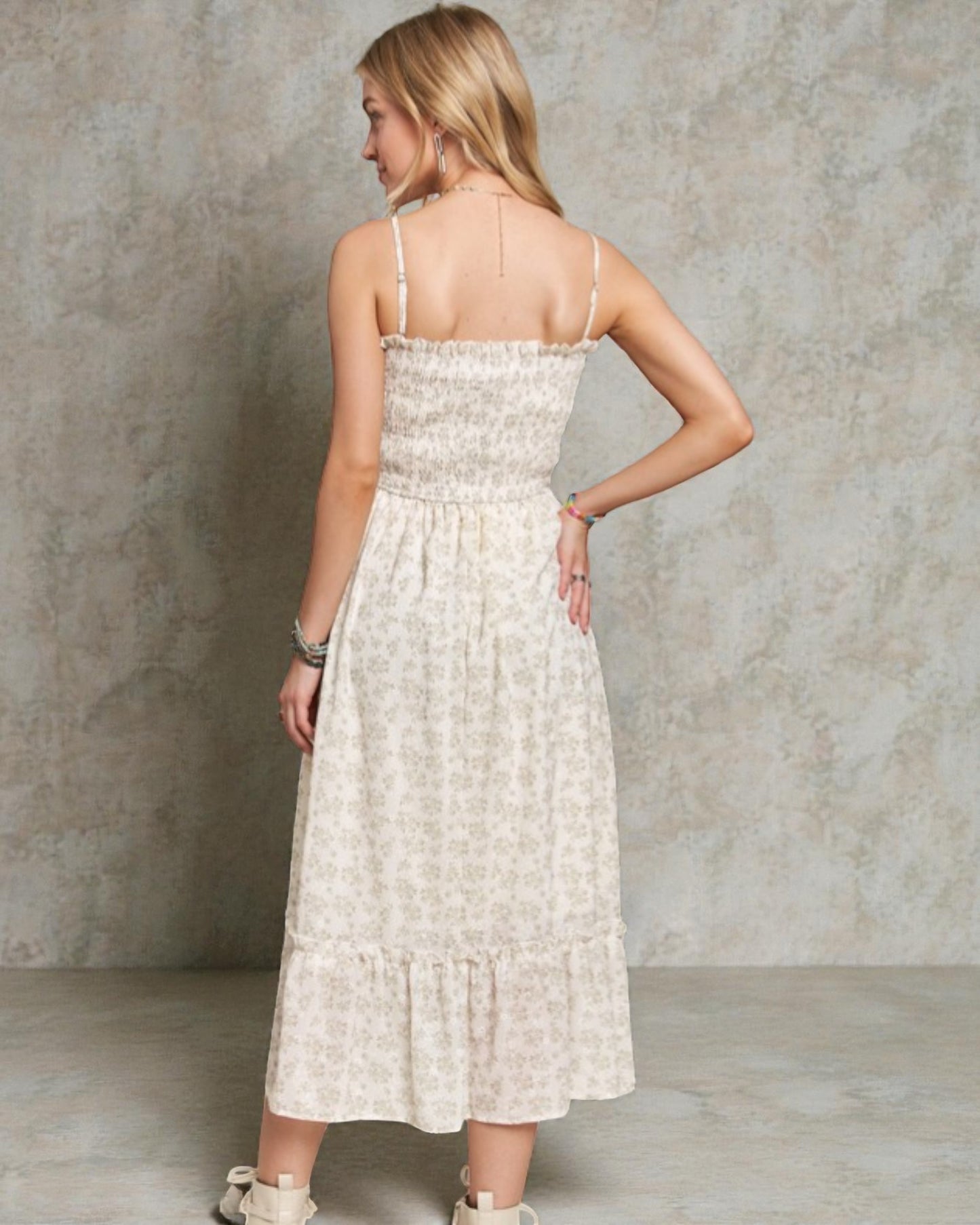 Woman wearing a light-colored dress against a neutral background