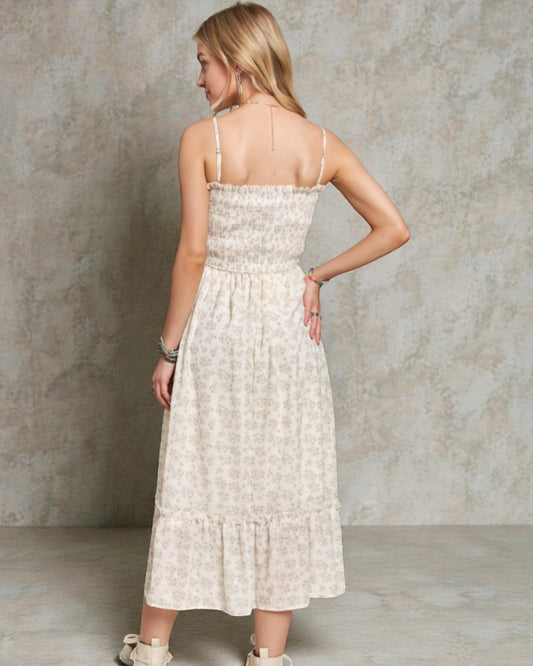 Woman wearing a light-colored dress against a neutral background