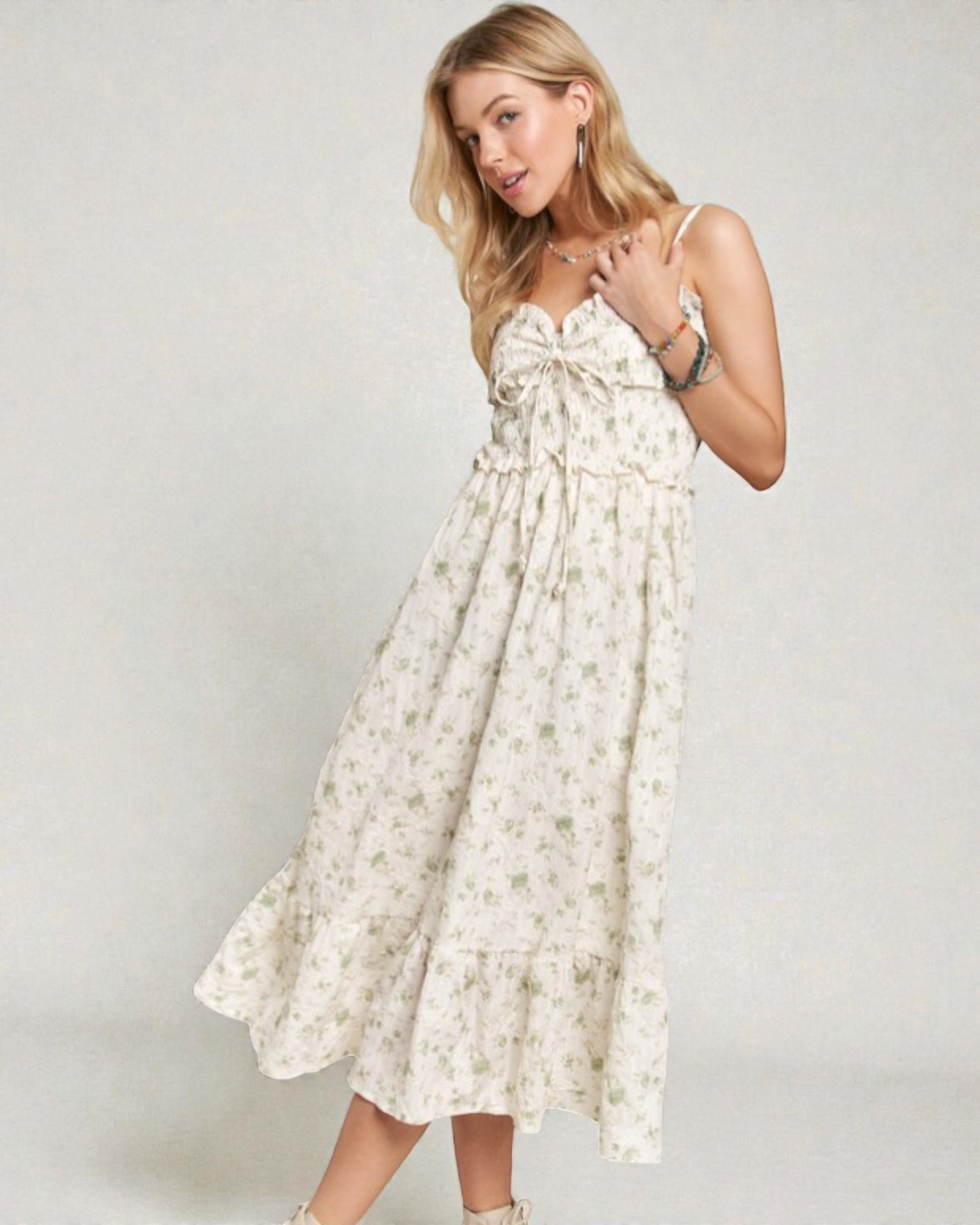 Woman wearing a floral dress against a plain background