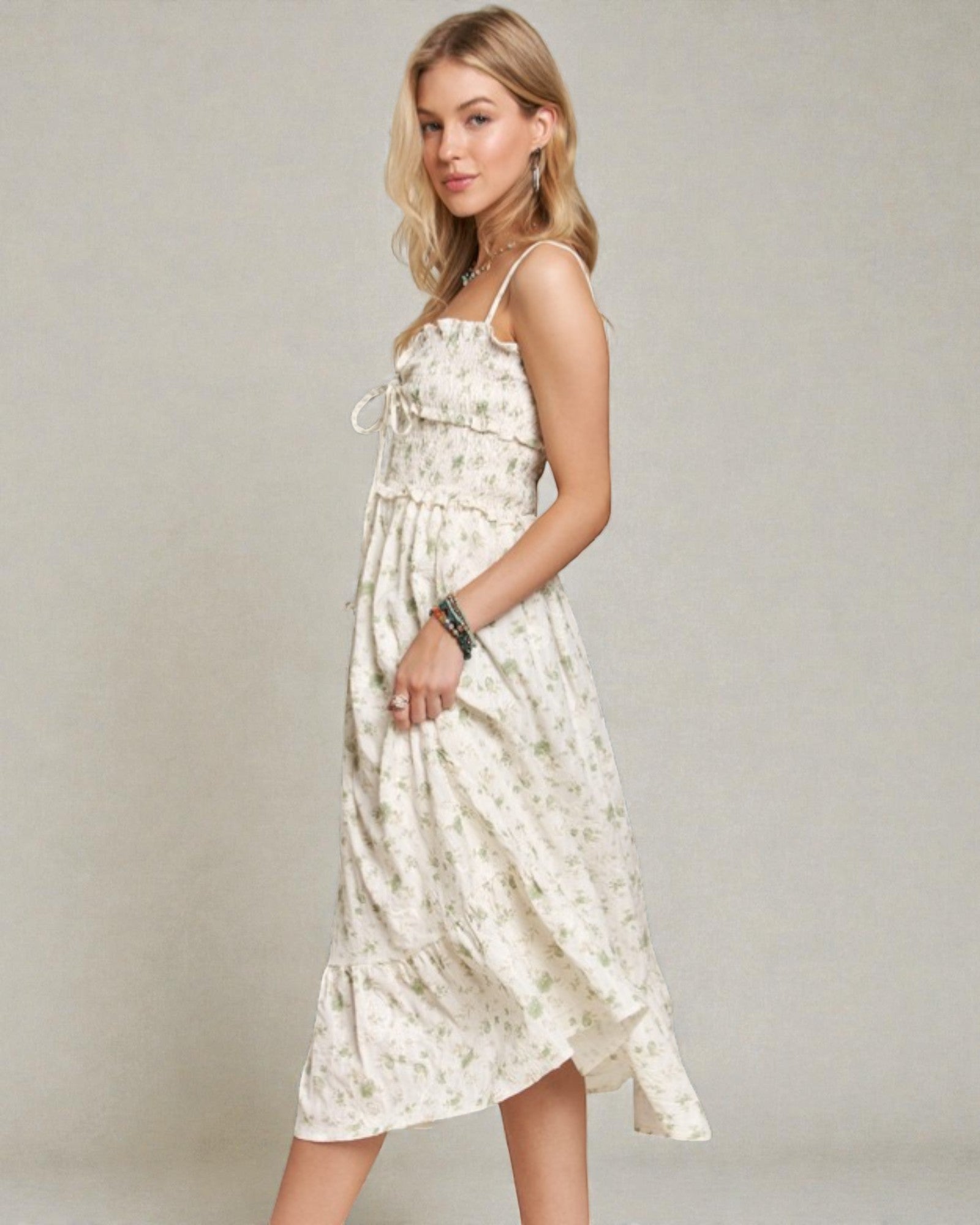 Woman wearing a floral dress against a plain background