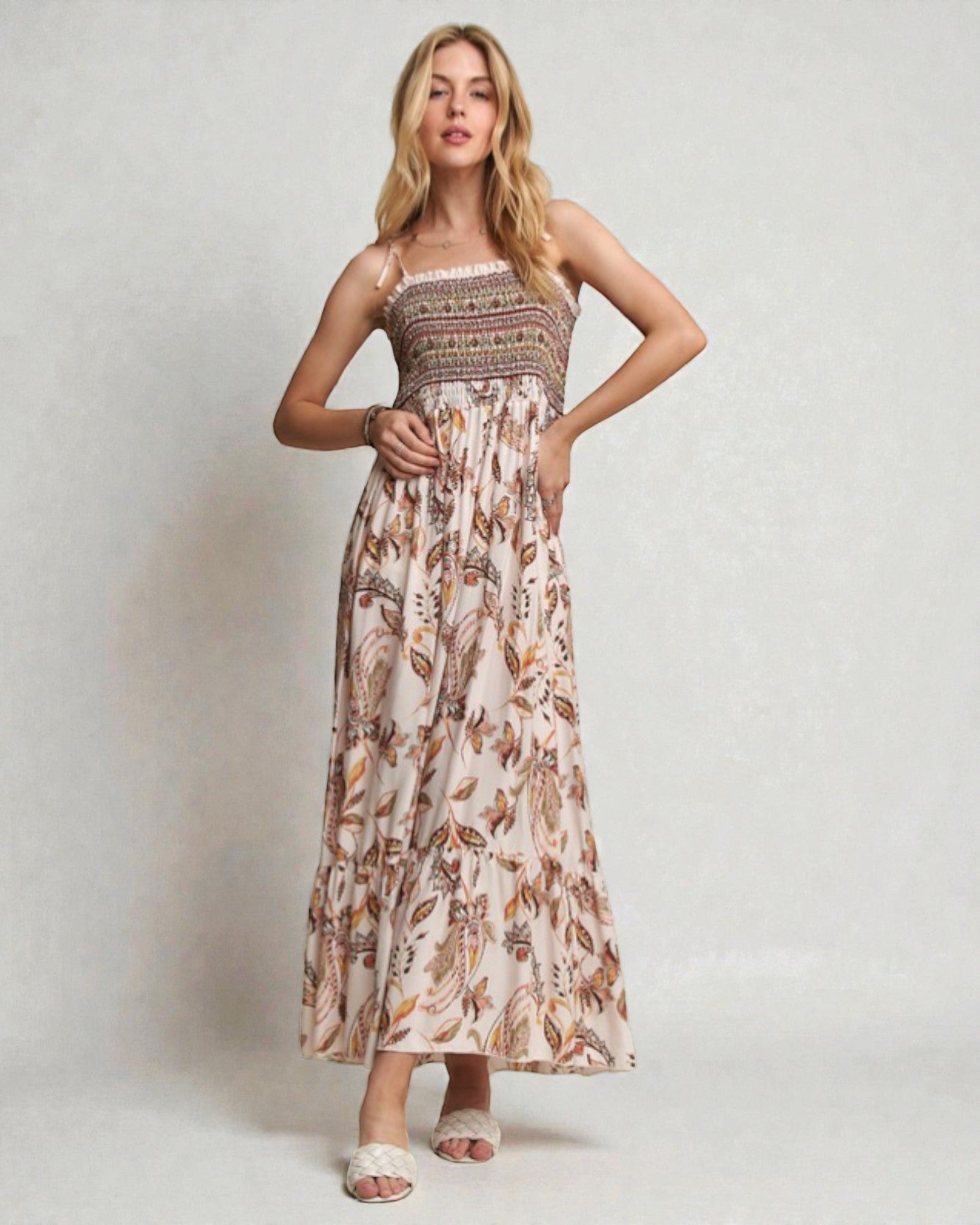 Woman wearing a floral dress against a plain background