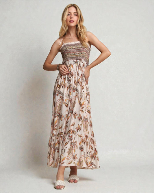 Woman wearing a floral dress against a plain background