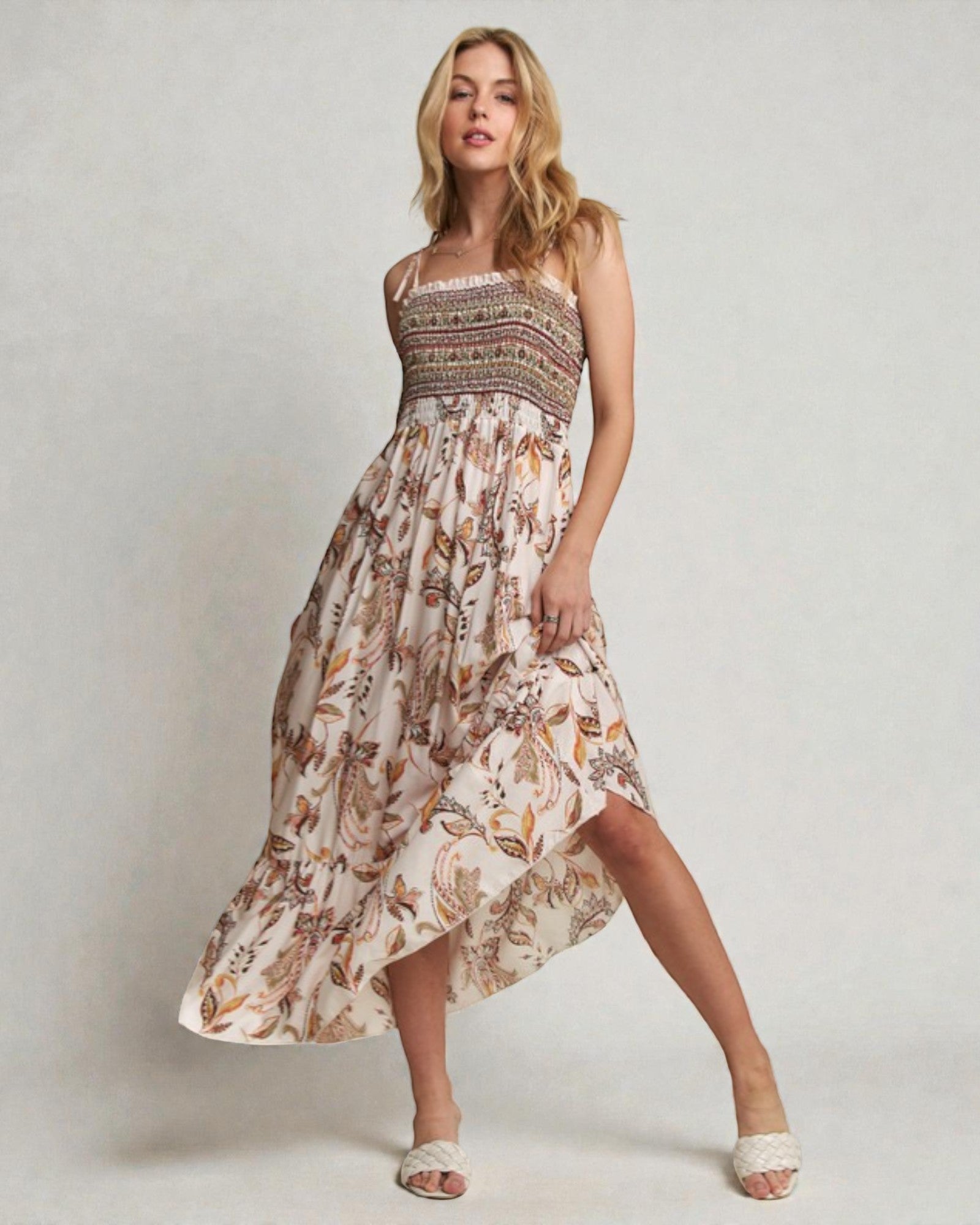 Woman wearing a patterned dress on a plain background