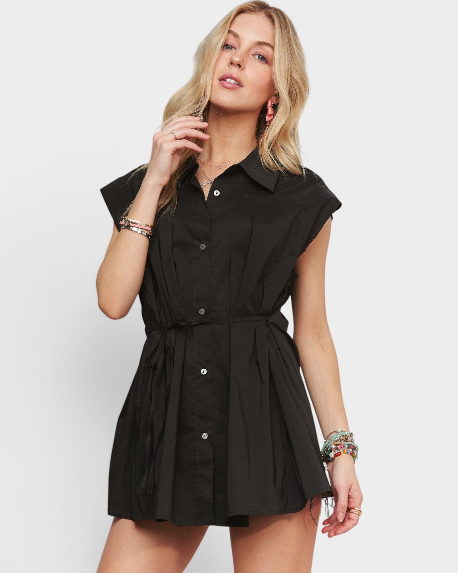 Woman wearing a black dress with a white background