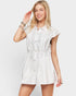 Woman wearing a white dress with a plain background