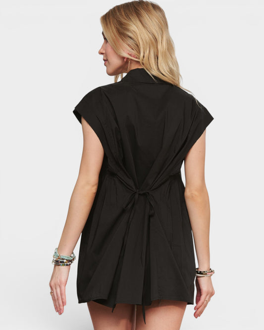 Woman wearing a black sleeveless dress on a white background
