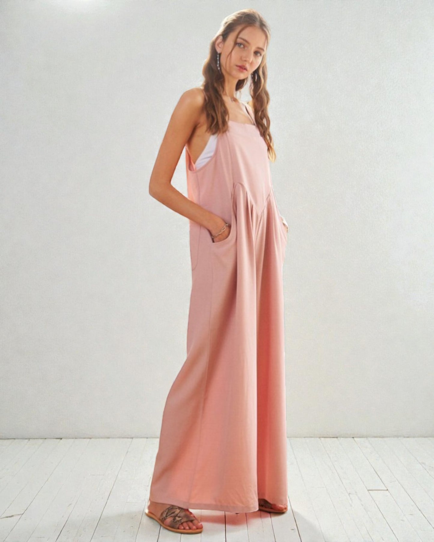 Woman wearing a long pink dress against a white background