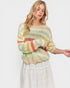 Woman wearing a colorful striped sweater on a white background
