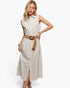 A woman models a sleeveless, button-front midi dress with vertical pinstripes in cream and beige, styled with a wide tan belt featuring a round wooden buckle, against a plain white studio background.