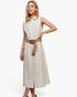 A woman models a sleeveless, button-front midi dress with thin vertical stripes in cream and beige, featuring a matching tan woven belt with a round wooden buckle, set against a plain white studio background.