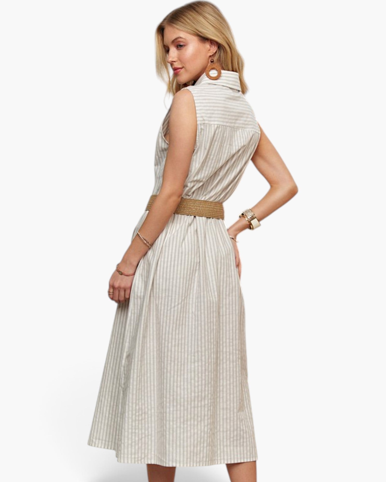 A woman modeling a sleeveless midi dress with vertical beige and white stripes, featuring a high mock neck and a matching tan woven belt, shown from a three-quarter back angle against a plain white background.