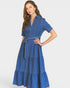 Woman wearing a blue denim dress on a white background