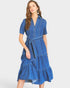 Woman wearing a blue denim dress on a white background