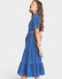 Woman wearing a blue denim dress on a white background