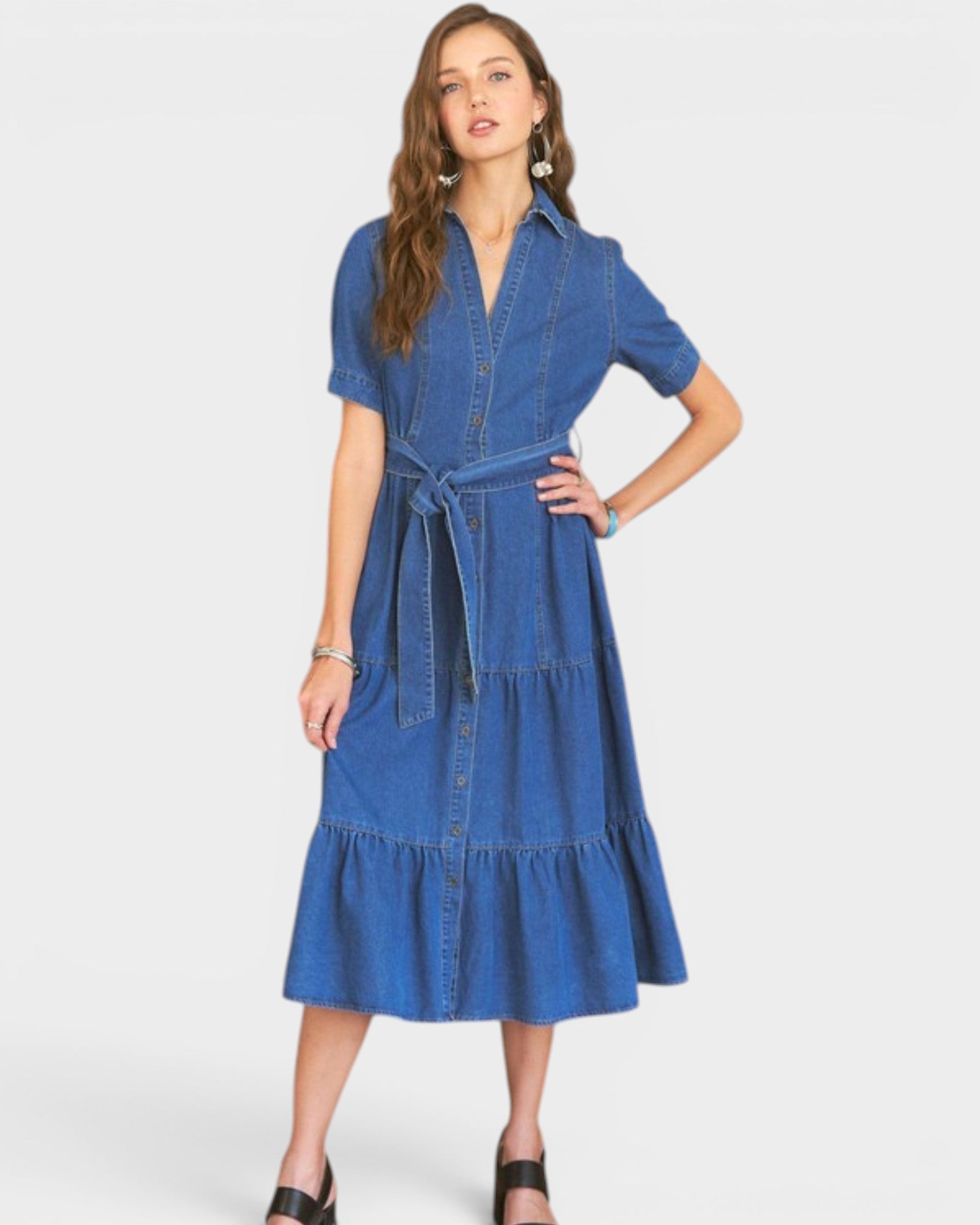 Woman wearing a blue denim dress on a white background