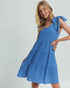 Woman wearing a blue dress with a white background
