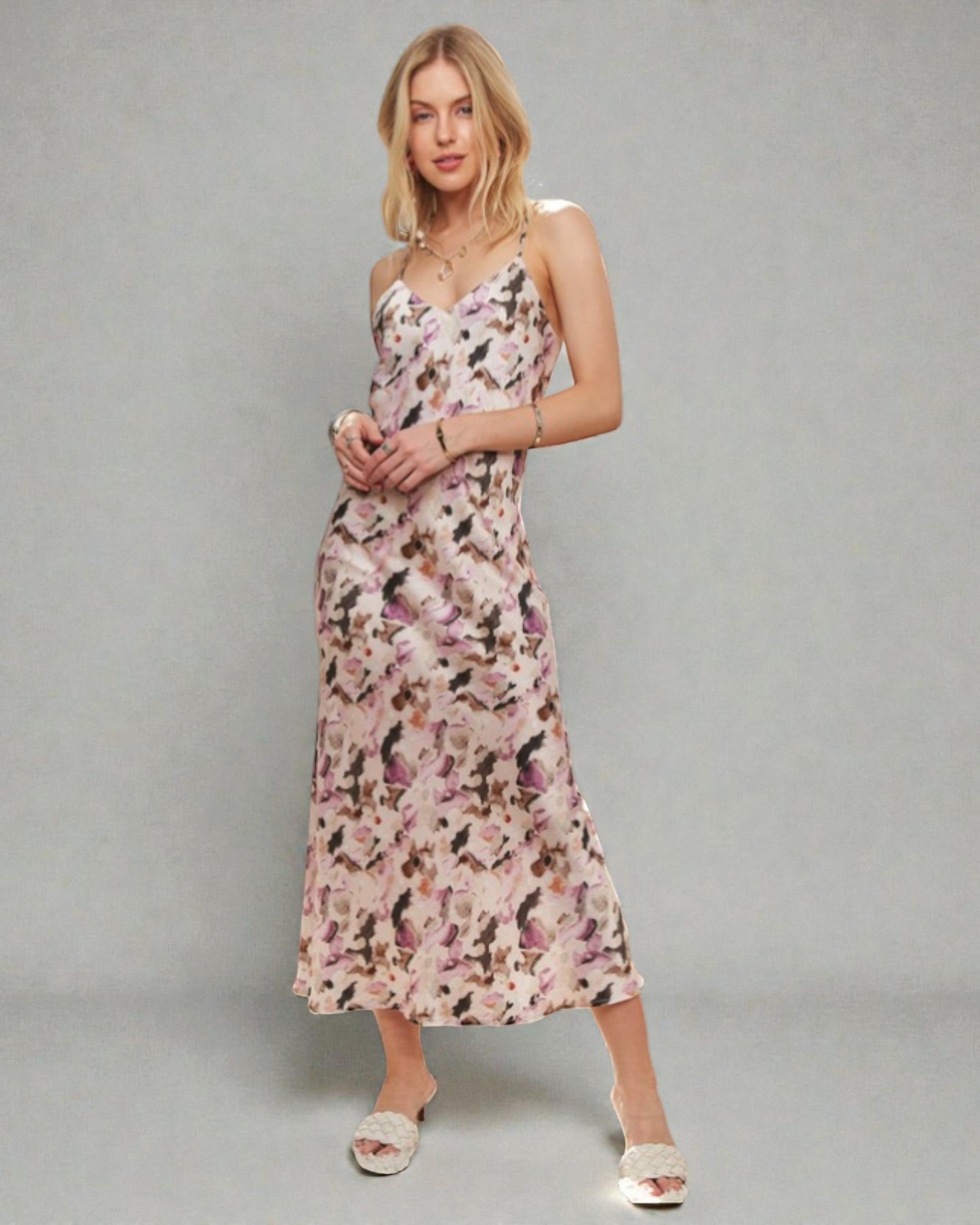 Woman wearing a floral dress against a gray background