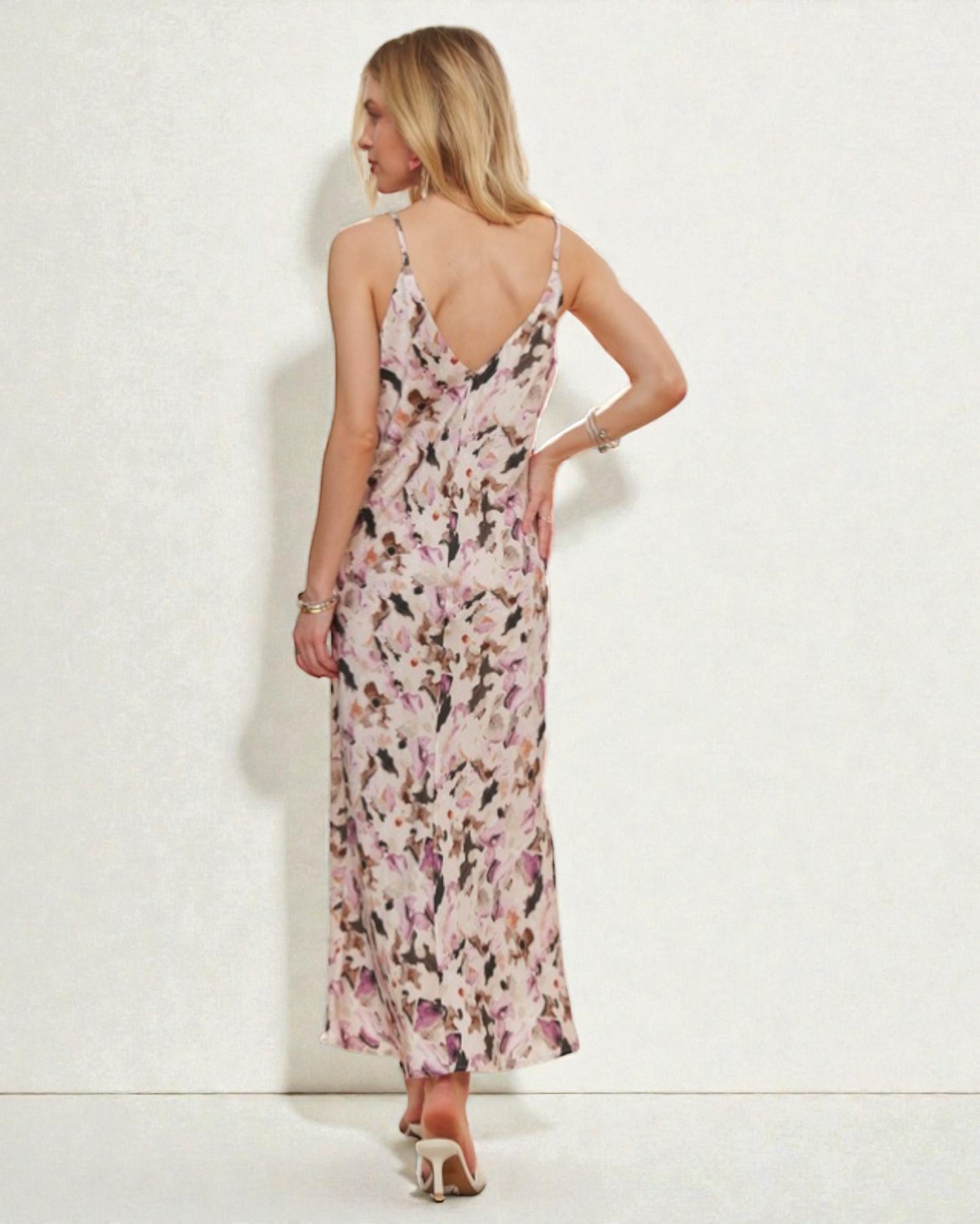 Woman wearing a floral dress against a white background