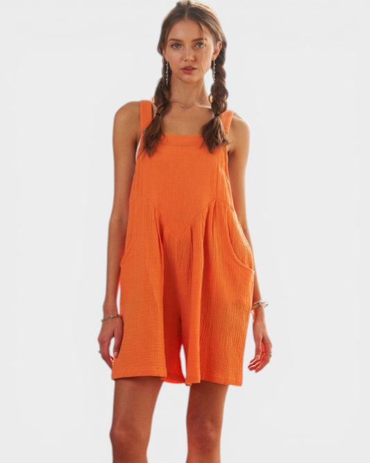 Woman wearing an orange dress on a white background