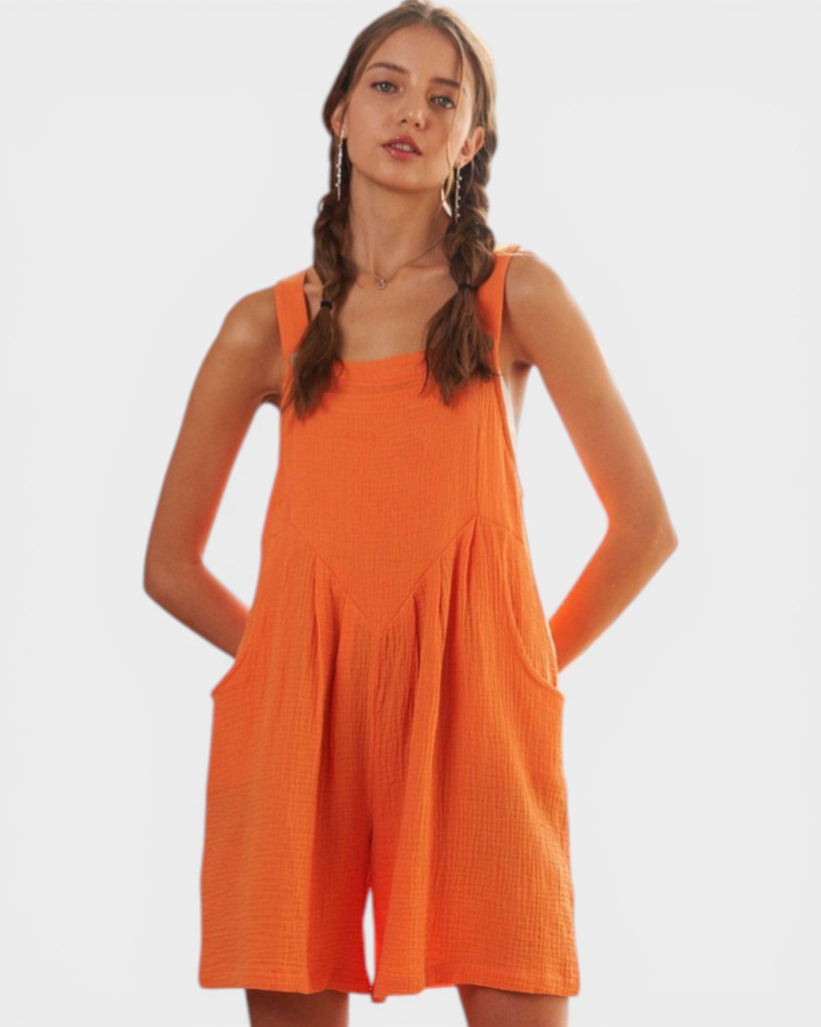 Woman wearing an orange dress against a white background