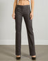 Dark gray pants worn by a person on a plain background