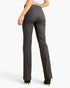 A model shown from the back wearing dark gray straight-leg jeans and black heels against a light gray studio background.