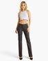 A woman modeling a pair of dark charcoal gray straight-leg pants with a white ribbed crop top, standing against a plain white studio background.