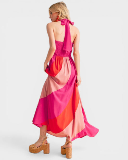 Woman wearing a colorful halter neck dress on a white background