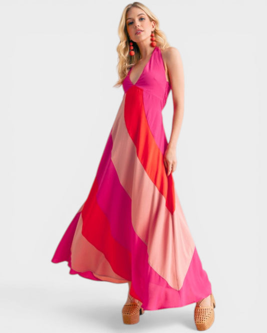 Woman wearing a colorful halter neck dress on a white background