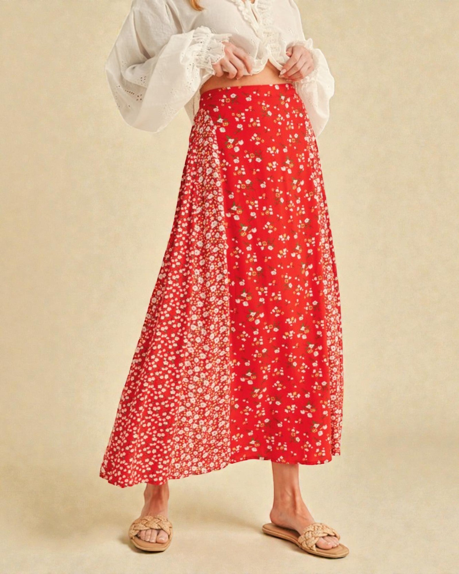 Red floral skirt worn by a person on a beige background