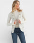 Woman wearing a light gray cardigan with floral embellishments on a white background