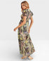 Woman wearing a patterned dress on a white background