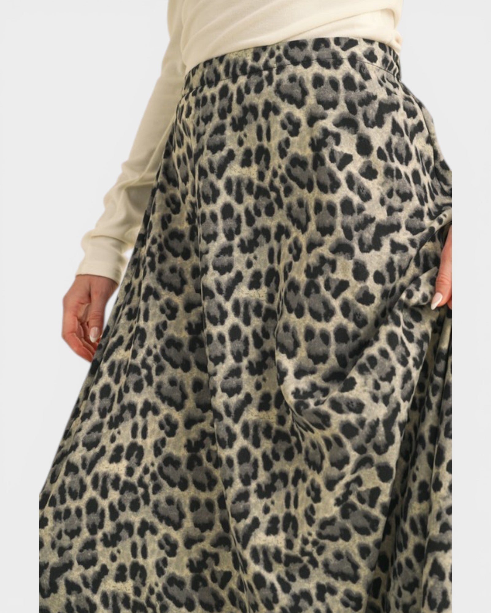 Leopard print skirt worn by a person on a plain background